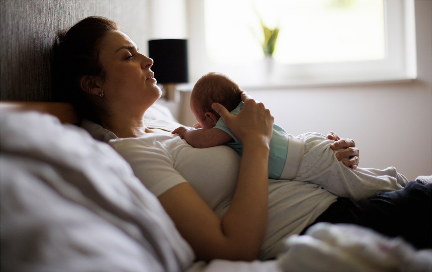 Mother resting with newborn